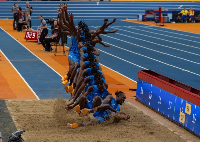 High jumper clearing bar indoors